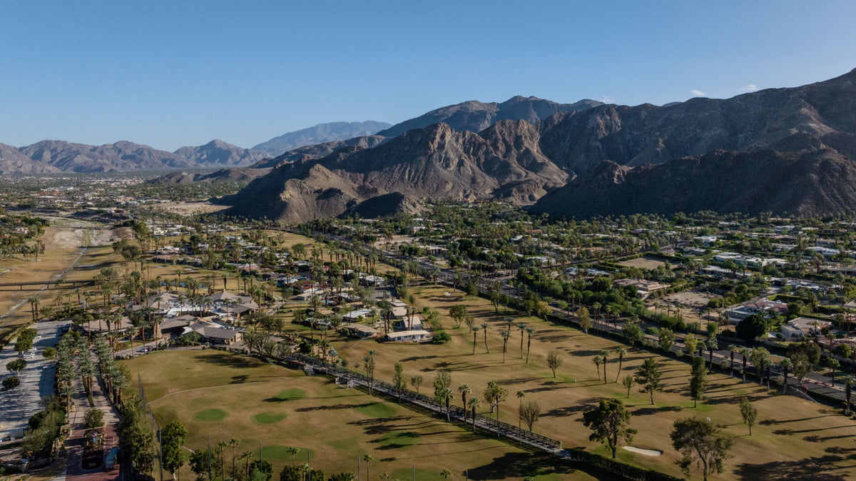 Aerial view of Thunderbird Country Club golf course with hillside neighborhoods and mountains in Rancho Mirage, photographed October 13, 2026 by Mark Miller