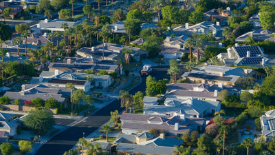 Aerial view of Victoria Falls homes, palm-lined streets and rooftop solar panels in Rancho Mirage.