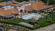 Close aerial view of Villa Portofino's clubhouse, terrace and pool, shown drained on September 10, 2026. Photo by Mark Miller, September 10, 2026.