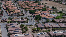 Aerial overview of Villa Portofino homes, clubhouse, pool area and palm-lined streets in Palm Desert. Photo by Mark Miller, September 10, 2026.