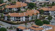 Mediterranean-style condominium buildings with tile roofs, balconies and palms at Villa Portofino in Palm Desert. Photo by Mark Miller, September 10, 2026.